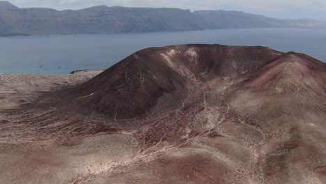 fantastic aerial shot in orbit of the yellow mountain and from where you can see the blue sea