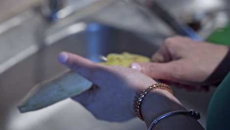 woman's hands peel a banana with knife. close-up