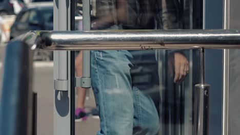 people come in and go out office door on sunny summer day