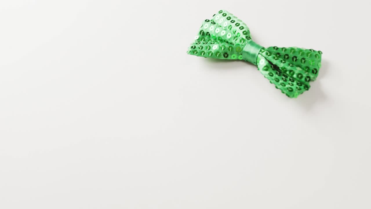 Video of st patrick's green bow tie with copy space on white background