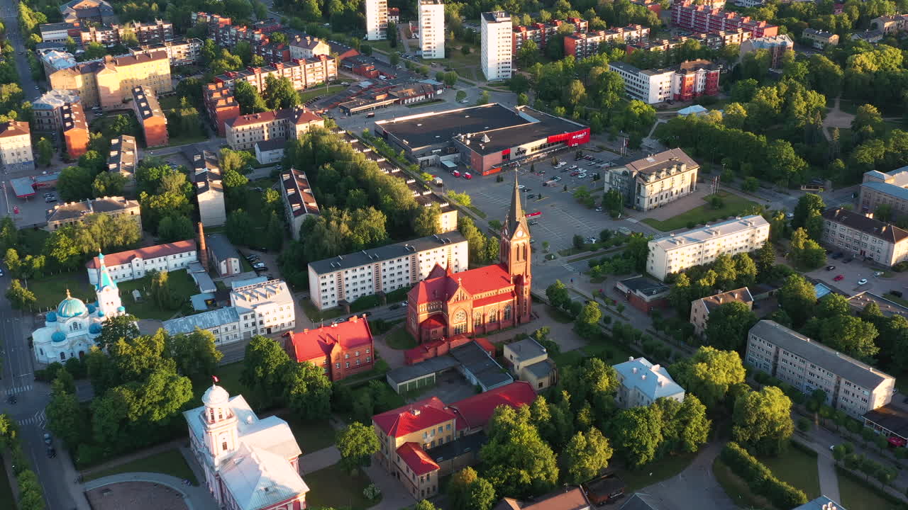 Aerial view of Jelgava city with church on a warm summer evening with golden sunlight