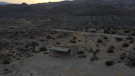 log cabin in tabernas desert at sunset with drone, almeria, spain