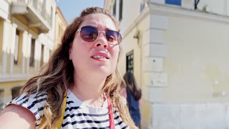 young tourist woman looking up at city architecture, athens, greece