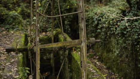 rusty undershot water turbine within the hidden valley in st stephen, cornwall