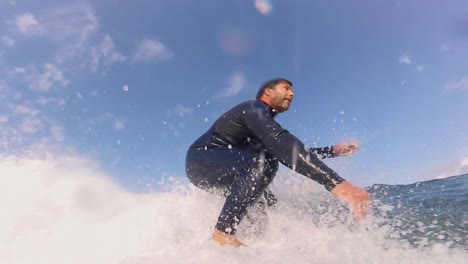 slow motion: extreme pro surfer surfing big barrel wave with a power snap on the end in cascais, portugal