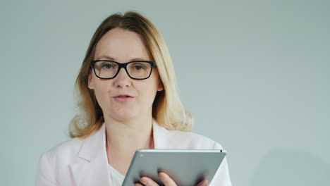 Lecturer-With-Tablet-In-Hand-Tells-Lesson-On-White-Background