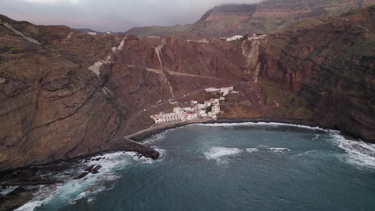Tilting drone footage of the bay off the coastal town of Alojera on La Gomera, one of the Canary Islands.