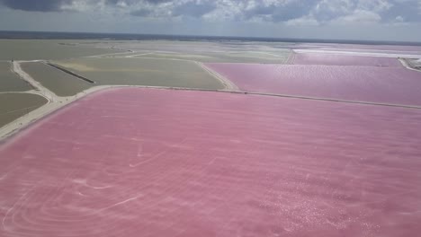 aerial: pink lake in mexico to produce salt