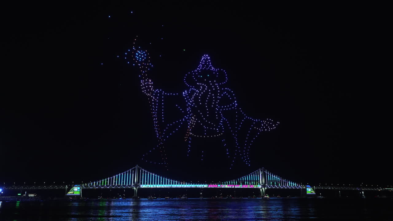 Gwangalli Beach Drone Light Show Above Gwangan Bridge in Busan, South Korea. Glowing Flying Drones Hive Froming Wizard with Staff Figure