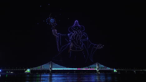 gwangalli beach drone light show above gwangan bridge in busan, south korea. glowing flying drones hive froming wizard with staff figure
