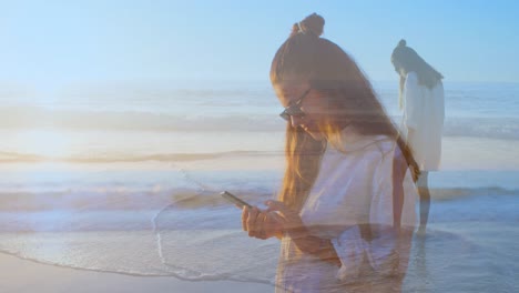 woman texting on the beach and playing on the shore 4k