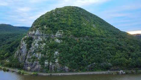 Aerial-drone-video-footage-of-an-appalachian-mountain-river-valley-with-a-beautiful-domed-mountain-with-a-road