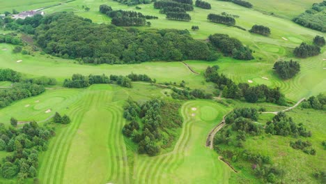 an aerial view over a green golf course in england