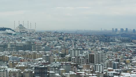 snowy cityscape with mosque in the background