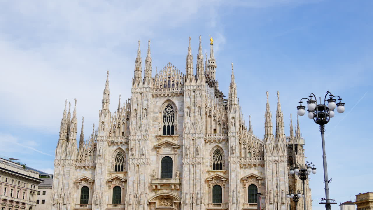 View of the Milan Cathedral in Italy over a cloudy sky in daylight