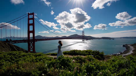 woman and the iconic golden gate bridge under a sunny sky