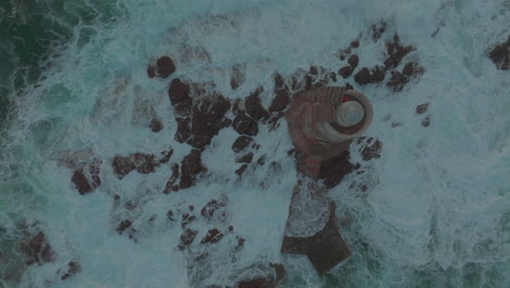 Mangiabarche-Lighthouse,-Sardinia:-Fantastic-aerial-view-from-above-of-the-beautiful-lighthouse-and-watching-the-fury-of-the-waves-during-the-sunset