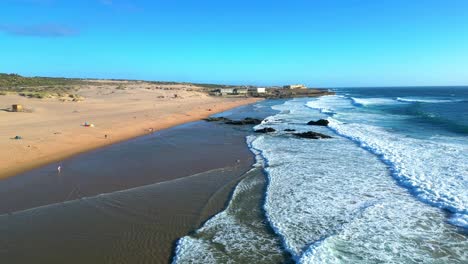 flying over the sea at guincho beach with the waves breaking,cascais,portugal