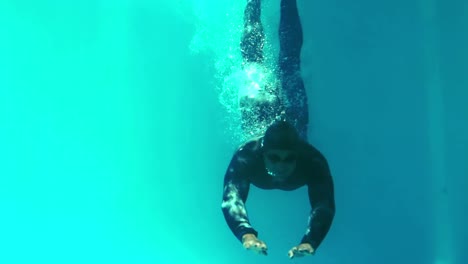 athletic man swimming underwater