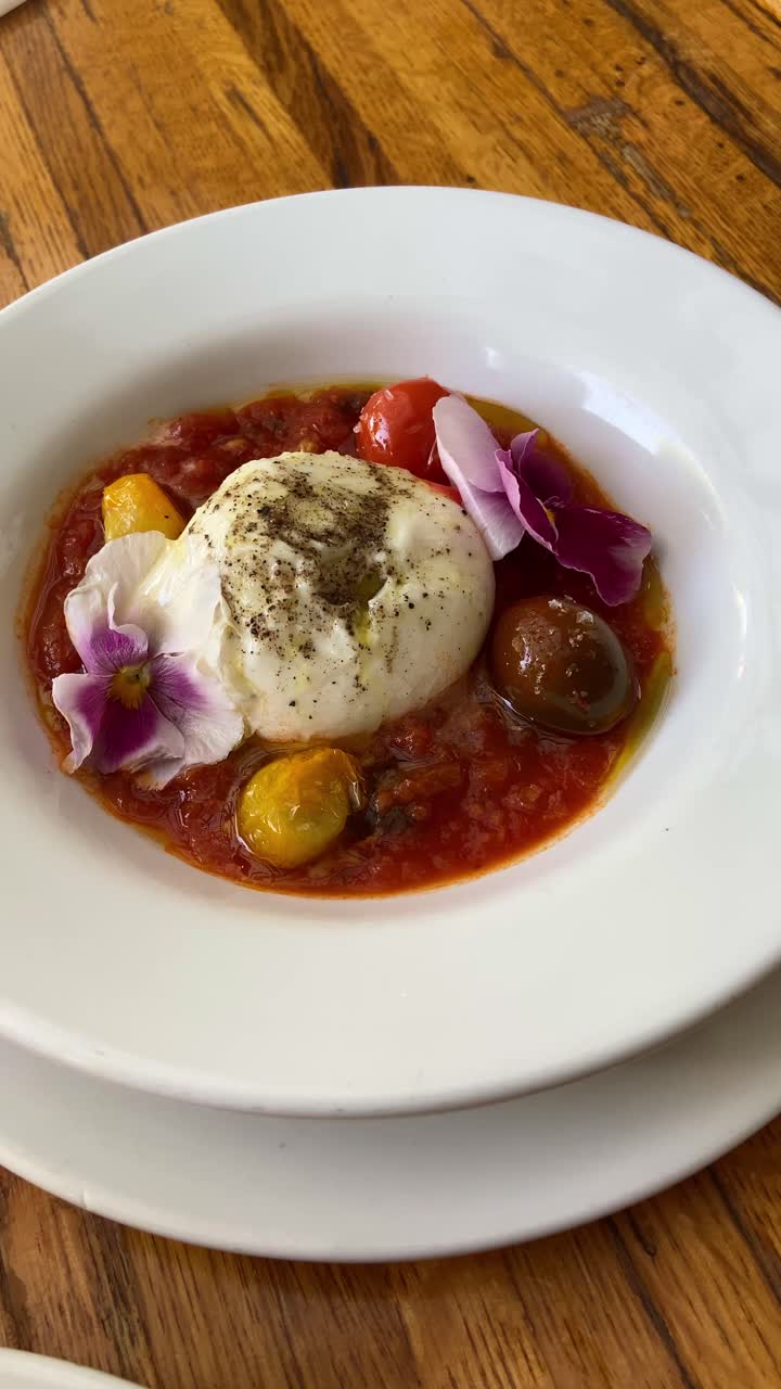 Point of view from phone filming italian restaurant dishes served for dinner or lunch on table. Food vlogger enjoying colorful plates with fancy quality food from italy. Healthy salads and fun drinks