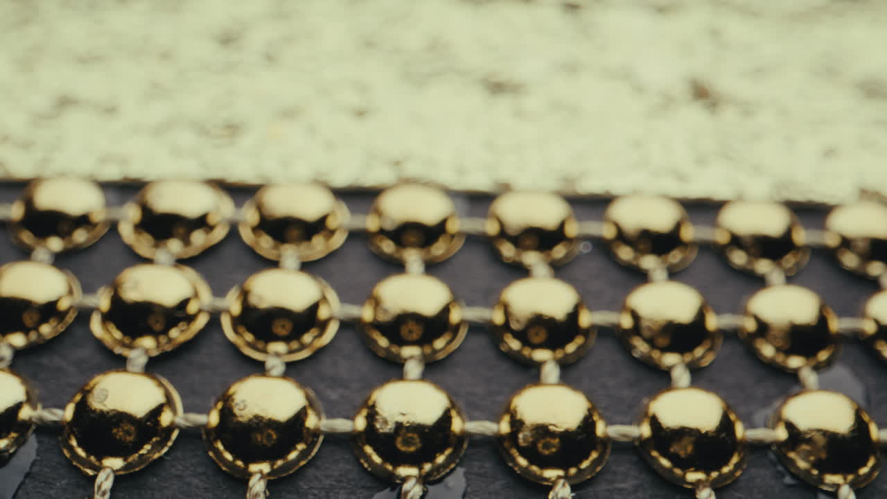 Close-up view of gold beads and decorative pattern