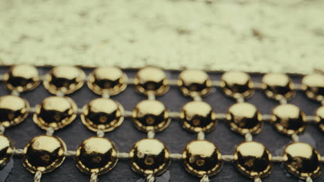 close-up view of gold beads and decorative pattern