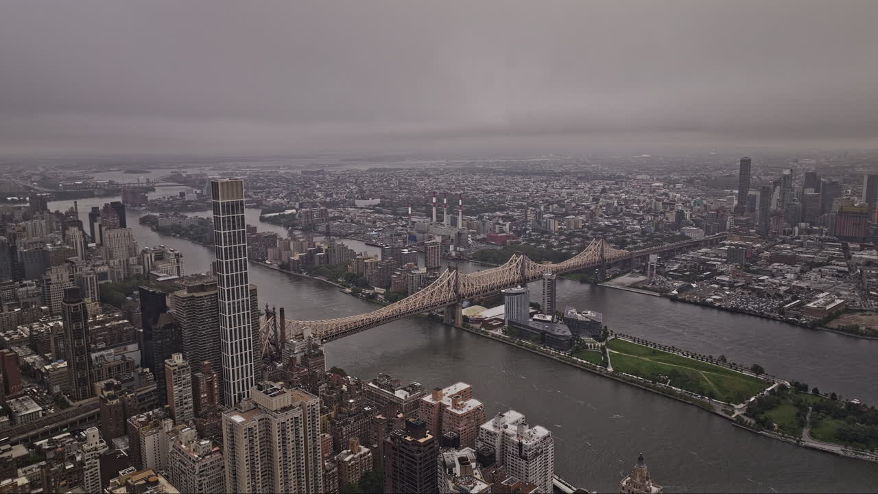 NYC New York Aerial v456 flyover Manhattan capturing Queensboro bridge over East river and Roosevelt Island, Queens cityscape shrouded in clouds and fog - Shot with Mavic 3 Pro Cine - September 2023