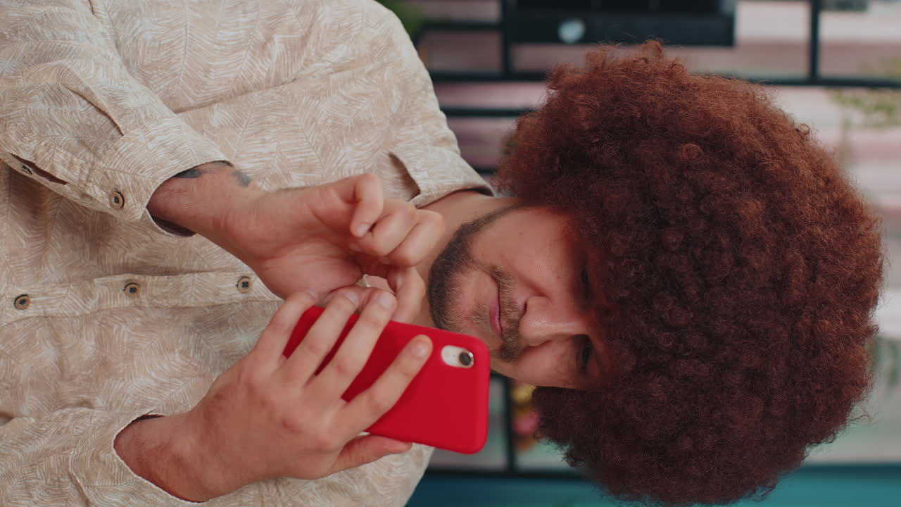 joven guapo en casa usar teléfono inteligente escribir navegación, wow sí descubrió gran gran victoria celebrar