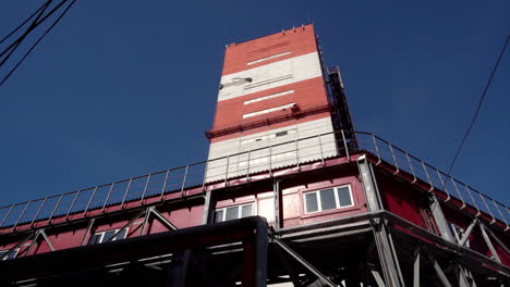 industrial building with red and white tower