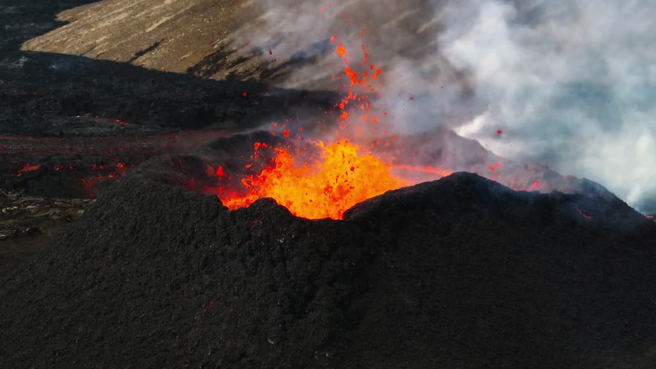 Aerial close up view over the volcanic eruption at Litli-Hrutur, Iceland, with lava and smoke coming out