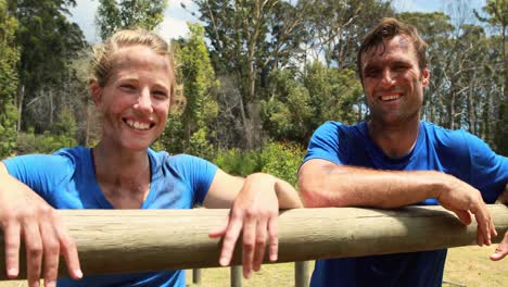 Fit-man-and-woman-interacting-with-each-other-during-obstacle-course