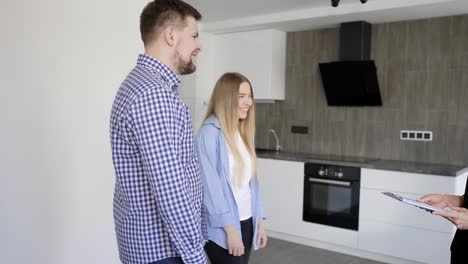 happy family of husband and wife buying new modern apartment