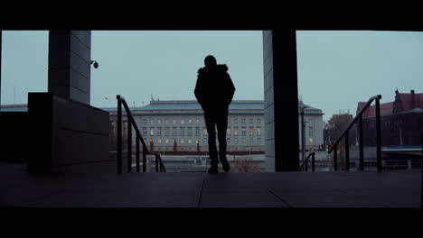 person walking through urban city building