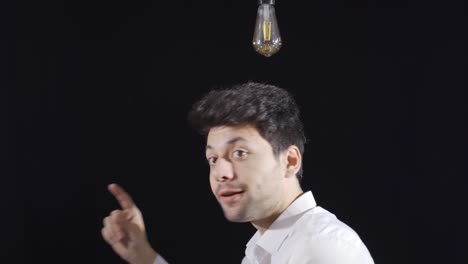 thoughtful man gets an idea, a symbolic lamp lights up above his head.