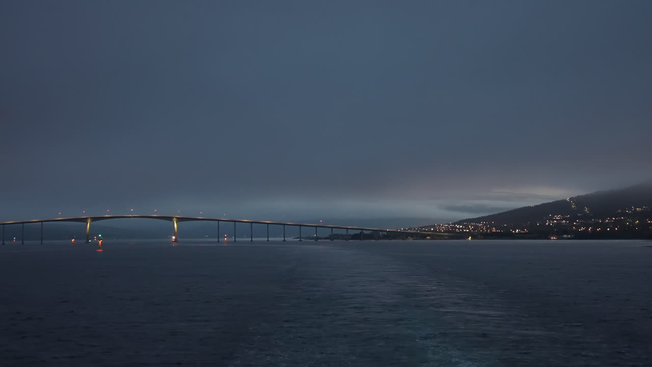timelapse, navegando desde tromsø, noruega, puente y vía fluvial en el crepúsculo de las noches blancas