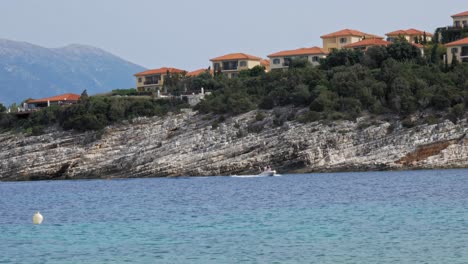 Small-Boat-Cruising-Near-Alexia-Beach-In-Greece---wide-shot