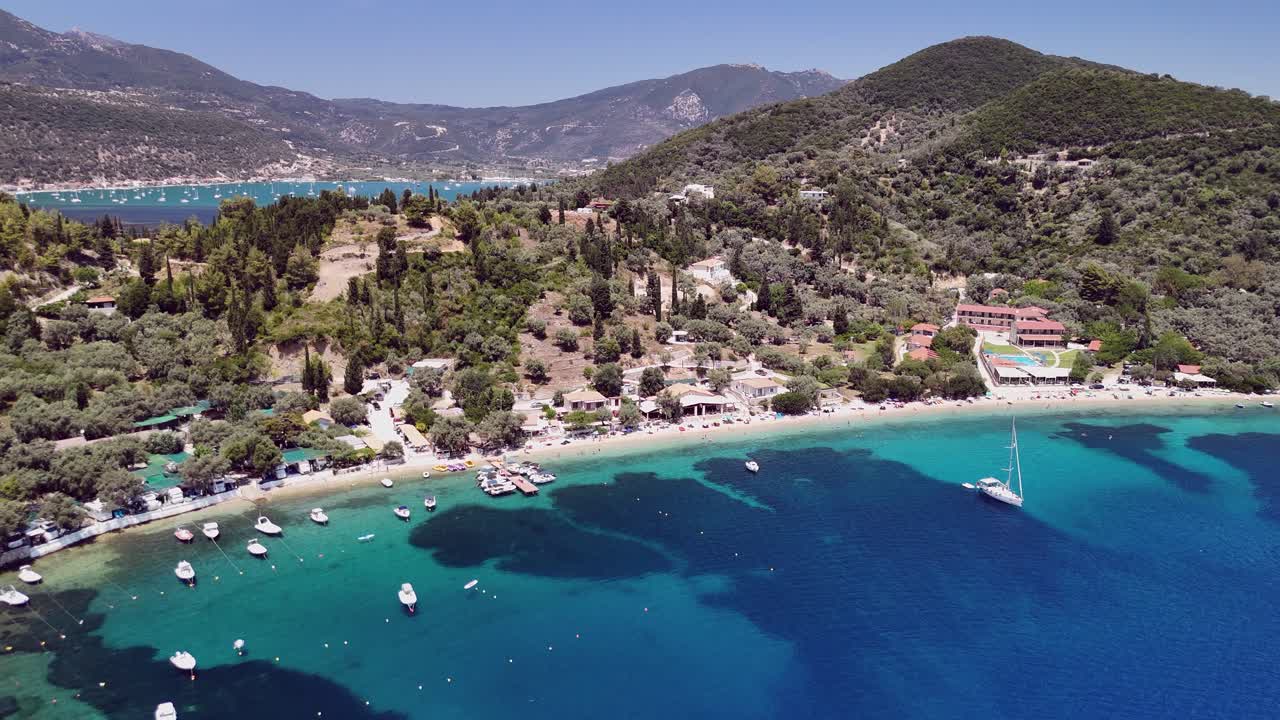 Aerial descends toward crescent beach Desimi near Nydri, Greece