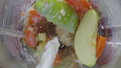 mixing milk fruits vegetables in blender bowl close up. preparing detox cocktail