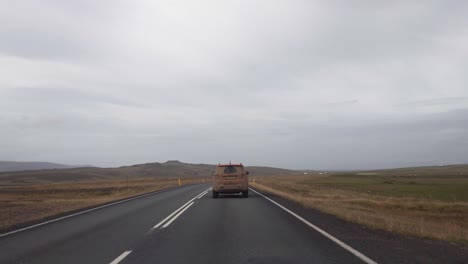 pov driving behind a dirty 4x4 car after a rough and wet gravel road in the mountains of iceland