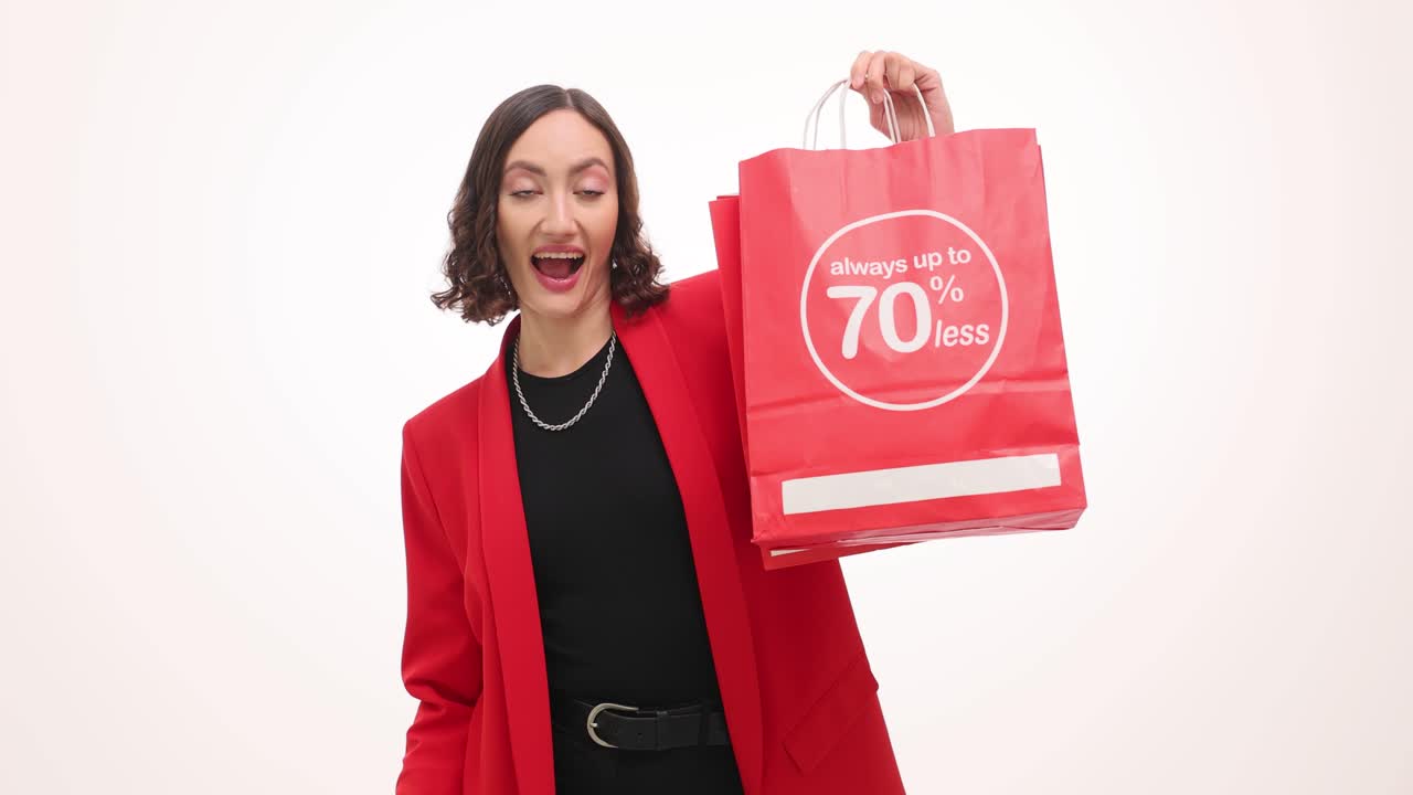 Happy woman with credit card and shopping bag showing 70% discount