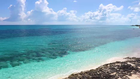 static shot of the ocean and rocky shore on exuma in the bahamas