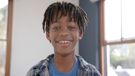 portrait of happy african american boy at home, slow motion