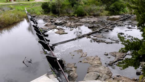 Aerial-video-of-the-dam-with-water-running-through-the-rocks