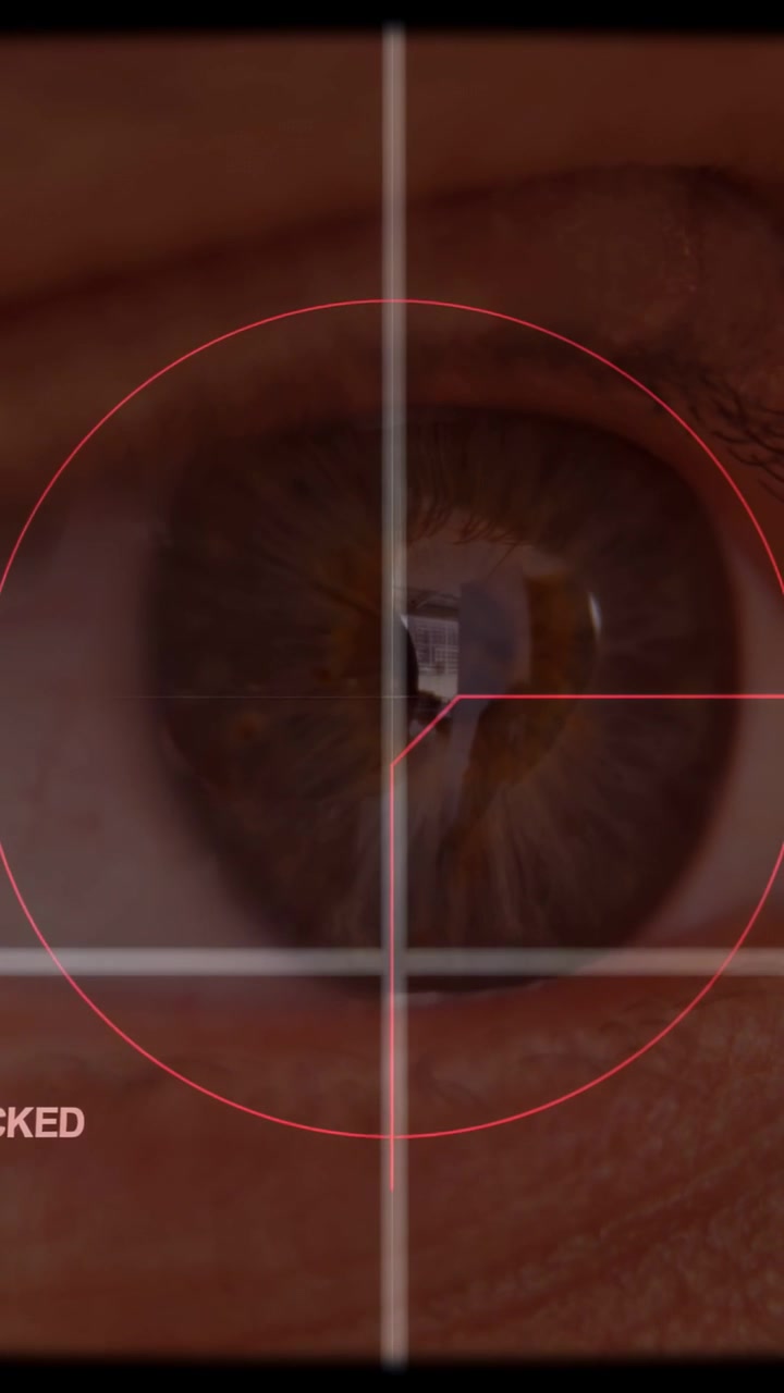 Vertical video: Reticle starting centered scanning brown iris, pointer sliding aligning glint