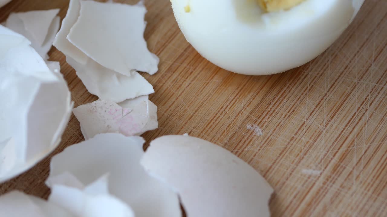 Close Up Of Cracked Eggshells On A Wooden Cutting Board
