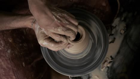 the potter makes a jug of clay. ceramist. a man makes a vase on a potter's wheel