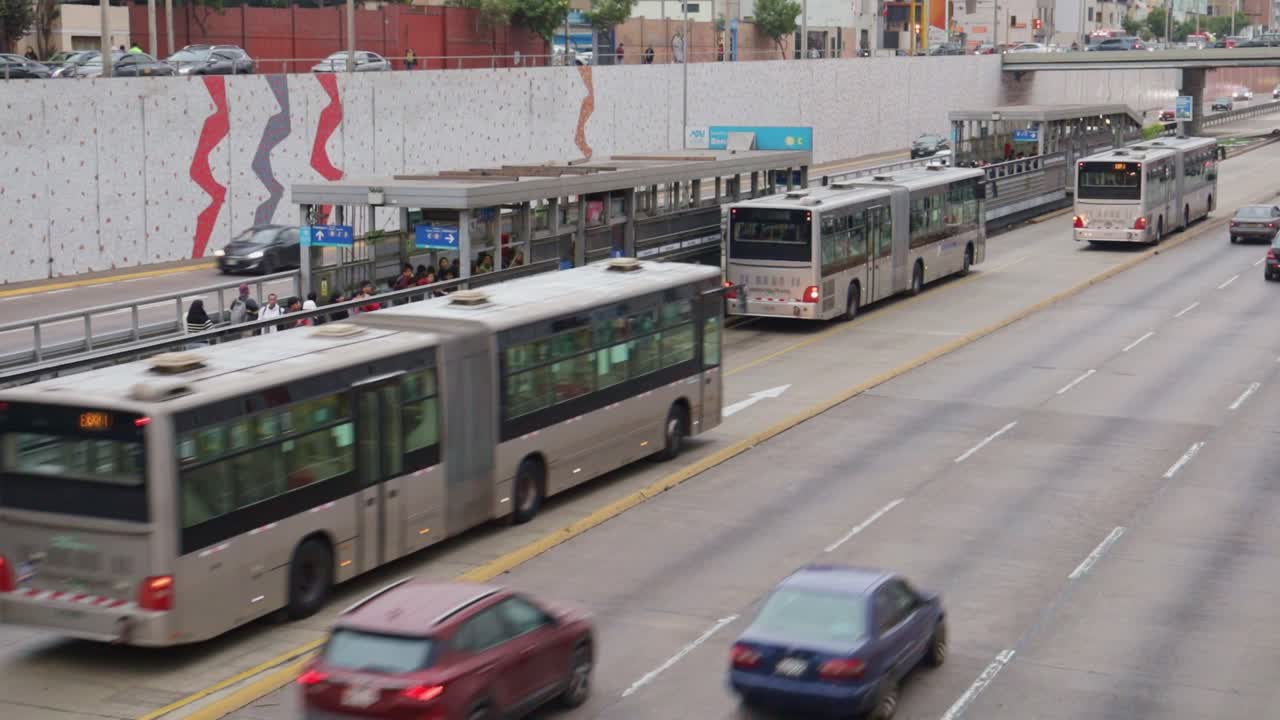 Articulated Buses Arriving and Departing at a Busy Urban Bus Station
