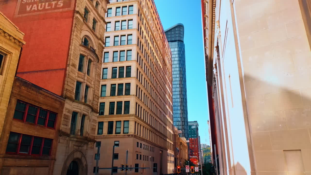 Old-fashioned design of the high-rise buildings in a big city. Low angle view. Walking by the streets of Pittsburg, Pennsylvania, USA