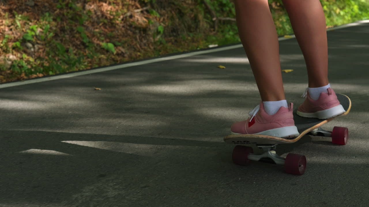Woman Skateboarding on Road