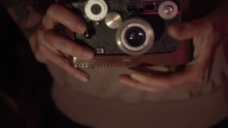 a photographer is holding a vintage argus rangefinder camera, emanating retro photography vibes